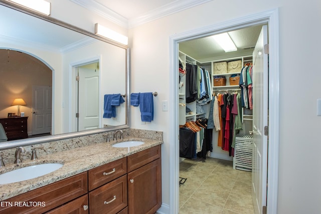 bathroom with crown molding and vanity