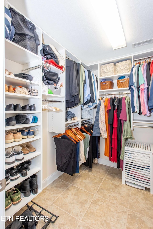 spacious closet featuring light tile patterned floors