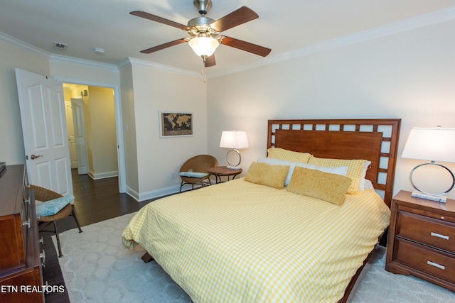 bedroom with ornamental molding, dark wood-type flooring, and ceiling fan