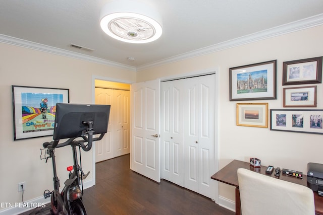 workout room featuring crown molding and dark hardwood / wood-style flooring