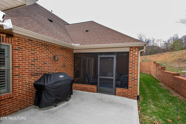 view of patio featuring grilling area and a sunroom