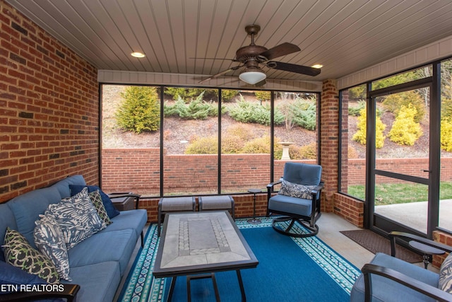 unfurnished sunroom with a wealth of natural light, wooden ceiling, and ceiling fan