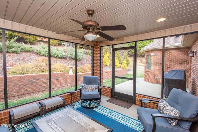 unfurnished sunroom with wood ceiling and ceiling fan