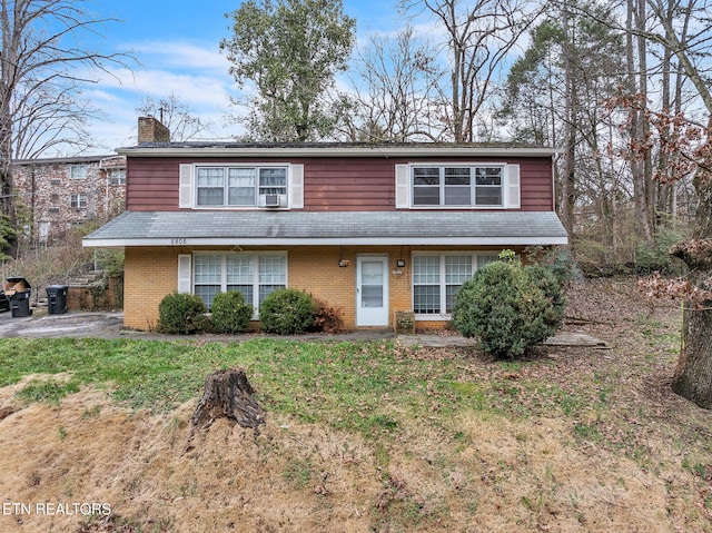 view of property featuring a front lawn