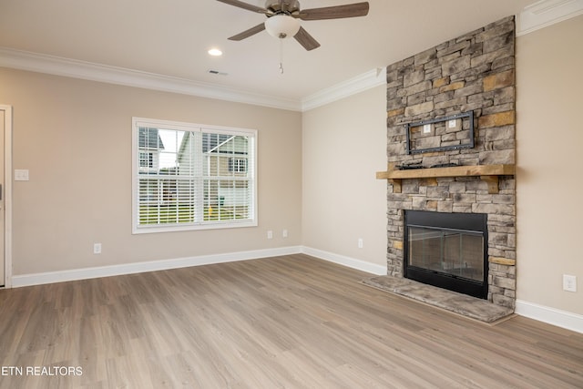 unfurnished living room with ornamental molding, wood-type flooring, and a fireplace