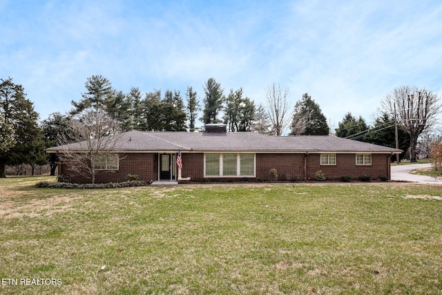 ranch-style home with brick siding and a front yard