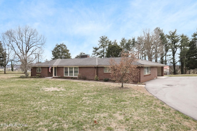 ranch-style home with a front lawn