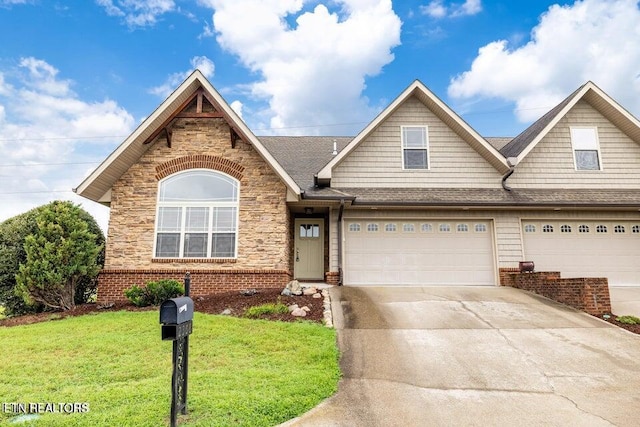 view of front of house with a garage and a front lawn