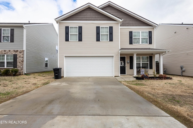 view of front of home with a garage, a front yard, and covered porch