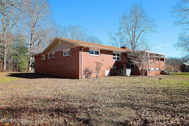 view of property exterior featuring a sunroom