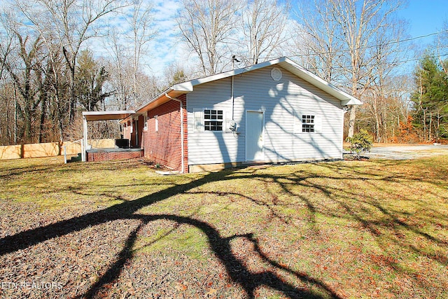 view of side of property with a yard