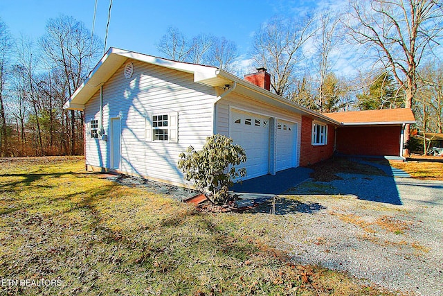 view of home's exterior featuring a garage and a yard