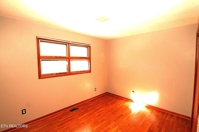 spare room featuring hardwood / wood-style floors