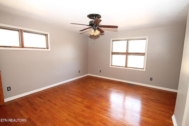 empty room featuring hardwood / wood-style flooring and ceiling fan