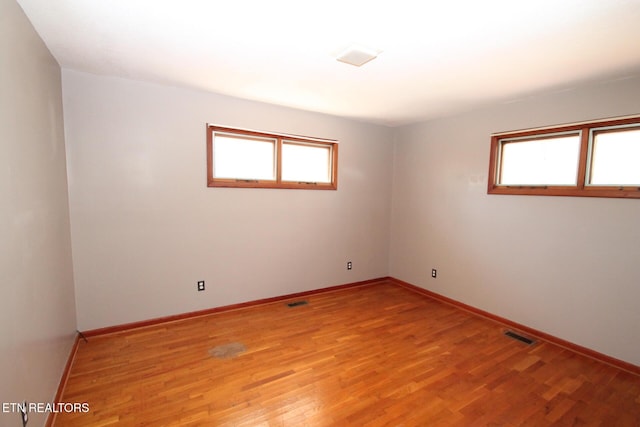 spare room with light hardwood / wood-style flooring