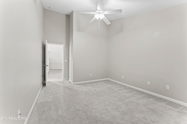 empty room featuring light colored carpet and ceiling fan