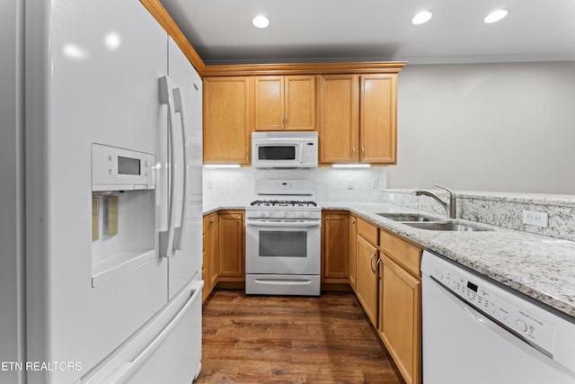 kitchen featuring sink, decorative backsplash, light stone countertops, dark wood-type flooring, and white appliances