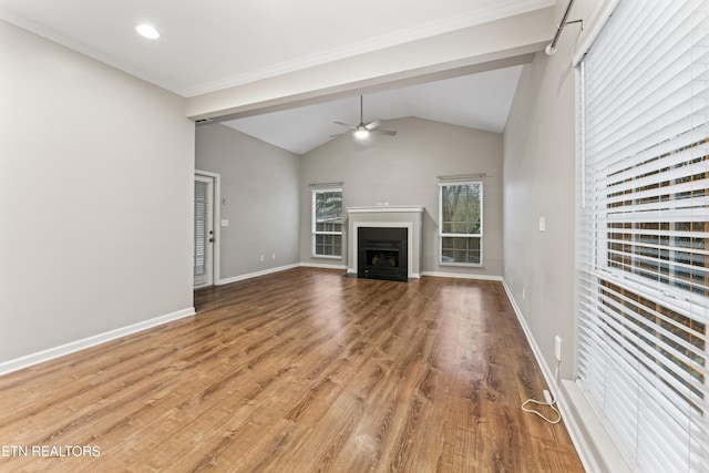 unfurnished living room with lofted ceiling, hardwood / wood-style flooring, and ceiling fan