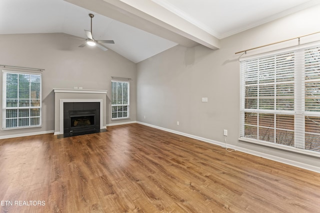 unfurnished living room featuring hardwood / wood-style flooring, ceiling fan, a fireplace, and vaulted ceiling