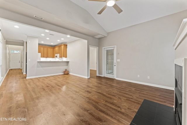 unfurnished living room with high vaulted ceiling, ceiling fan, and light hardwood / wood-style flooring