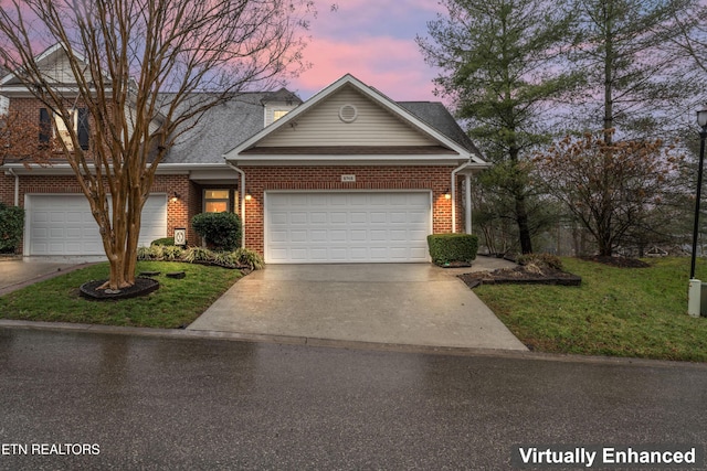 view of front of property with a garage and a lawn