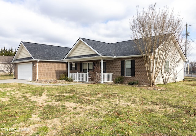 ranch-style house featuring covered porch, a front yard, and a garage