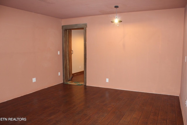 empty room with dark wood-type flooring