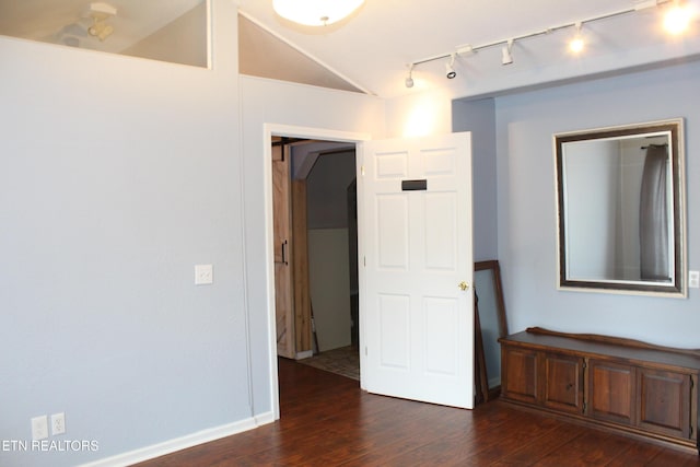 unfurnished room with dark wood-type flooring and lofted ceiling