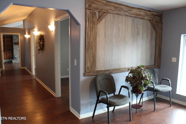 sitting room with dark wood-type flooring