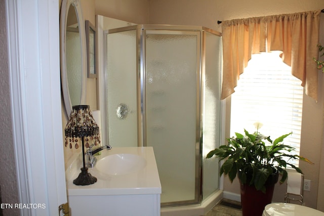 bathroom with an enclosed shower and vanity