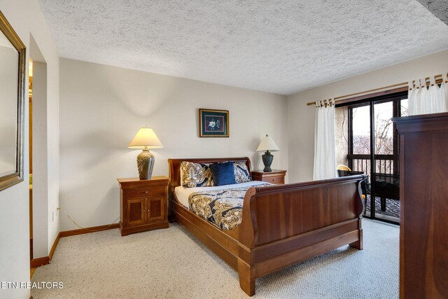 1130 Ski View Dr, Gatlinburg, TN 37738 - bedroom featuring baseboards, a textured ceiling, carpet flooring, and access to exterior