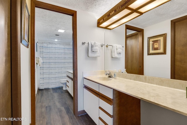 1130 Ski View Dr, Gatlinburg, TN 37738 - bathroom featuring a shower with shower curtain, toilet, wood finished floors, a textured ceiling, and vanity
