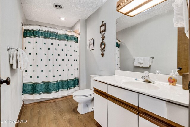 1130 Ski View Dr, Gatlinburg, TN 37738 - bathroom with visible vents, toilet, a textured ceiling, vanity, and wood finished floors