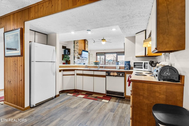 1130 Ski View Dr, Gatlinburg, TN 37738 - kitchen with a peninsula, white appliances, white cabinetry, and light countertops