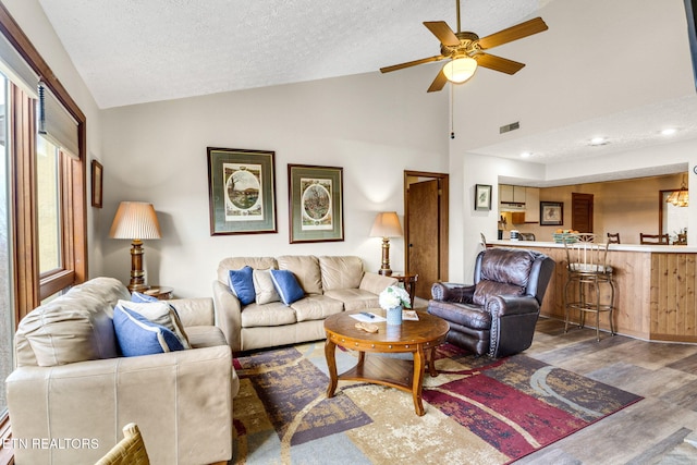 1130 Ski View Dr, Gatlinburg, TN 37738 - living area with visible vents, lofted ceiling, dark wood-style floors, ceiling fan, and a textured ceiling
