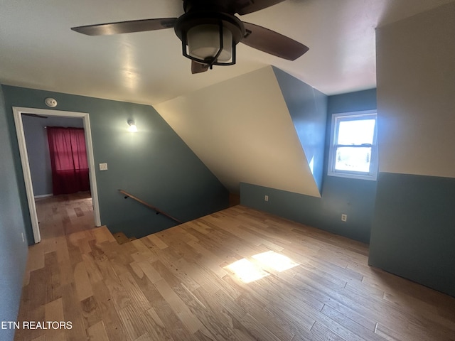 additional living space featuring lofted ceiling, light hardwood / wood-style flooring, and ceiling fan