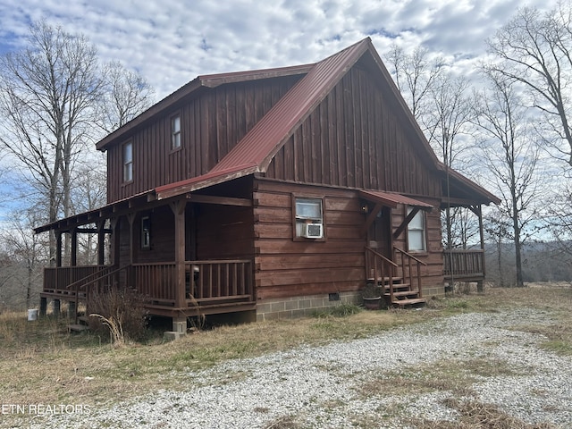 log home featuring cooling unit and covered porch