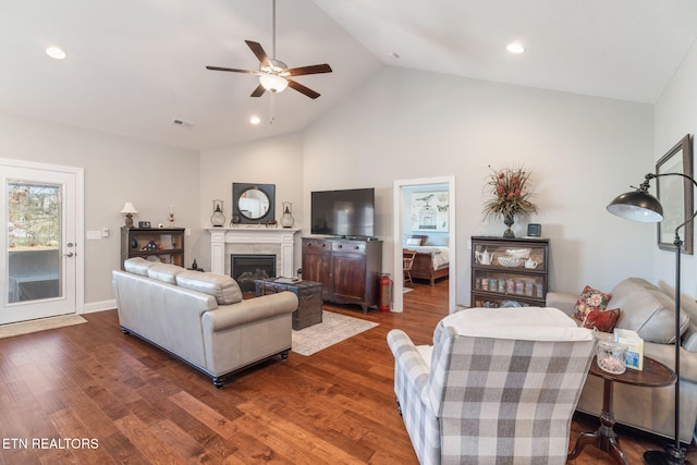 living area with dark wood-style floors, a fireplace, and recessed lighting