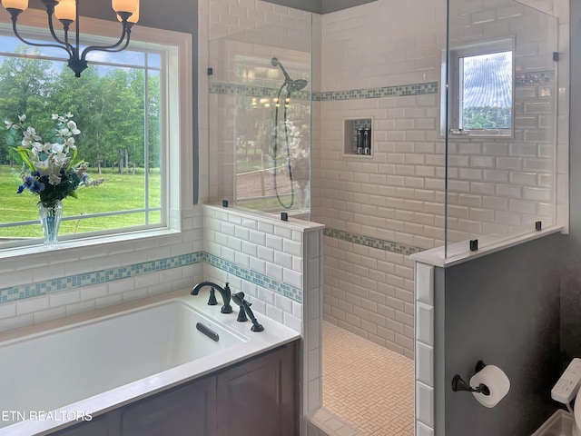 bathroom featuring separate shower and tub