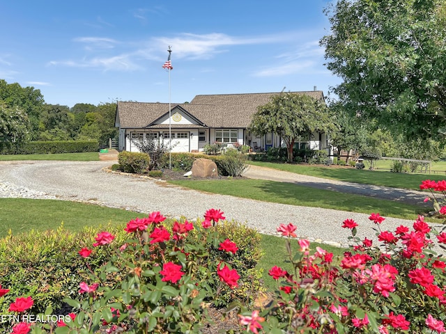 view of front of house featuring a garage and a front lawn