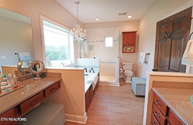 full bathroom with a chandelier, vanity, wood-type flooring, plus walk in shower, and toilet