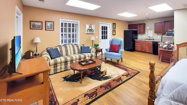 living room featuring sink and light wood-type flooring