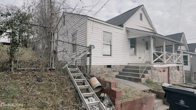 view of side of home featuring a porch