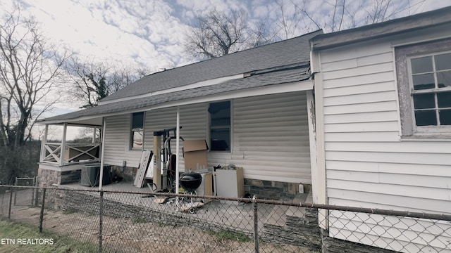 back of house with central air condition unit