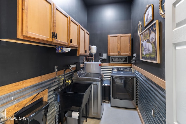 laundry area featuring sink, washer and dryer, cabinets, and a towering ceiling