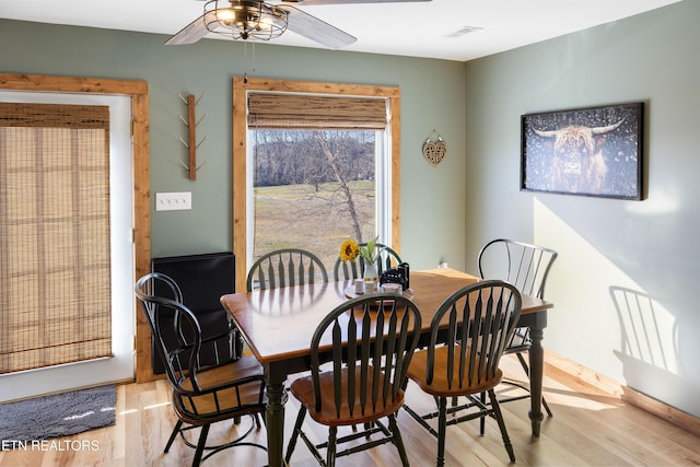 dining space featuring light wood-type flooring and ceiling fan