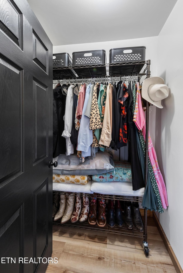 spacious closet featuring hardwood / wood-style floors