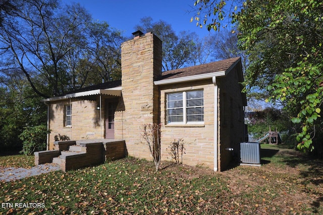 view of front facade featuring central AC unit and a playground