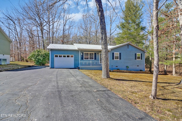 ranch-style home featuring metal roof, a garage, covered porch, driveway, and crawl space