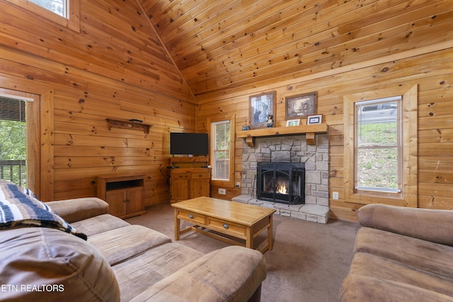 living room with carpet flooring, a fireplace, high vaulted ceiling, and wood walls